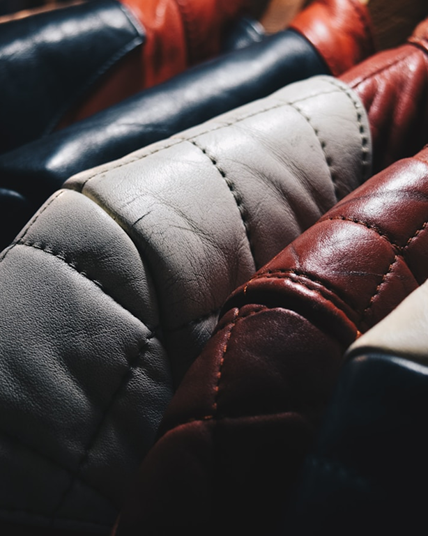 Jackets on hangers showing leather aging and patina